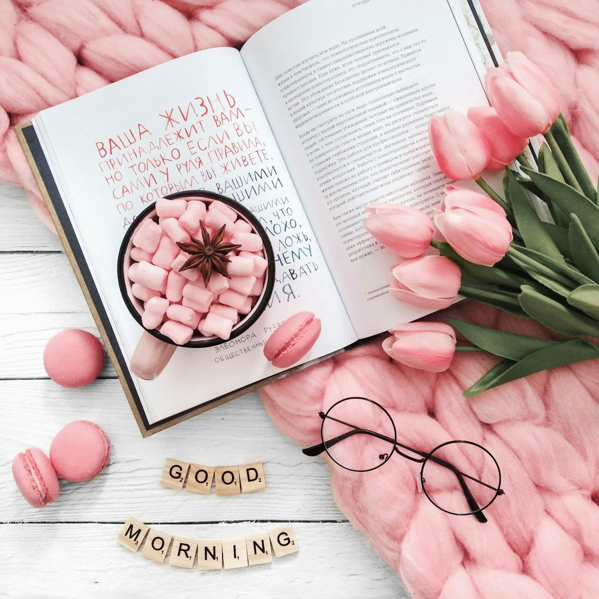 Pink tulips, macarons, and a book with good morning message.