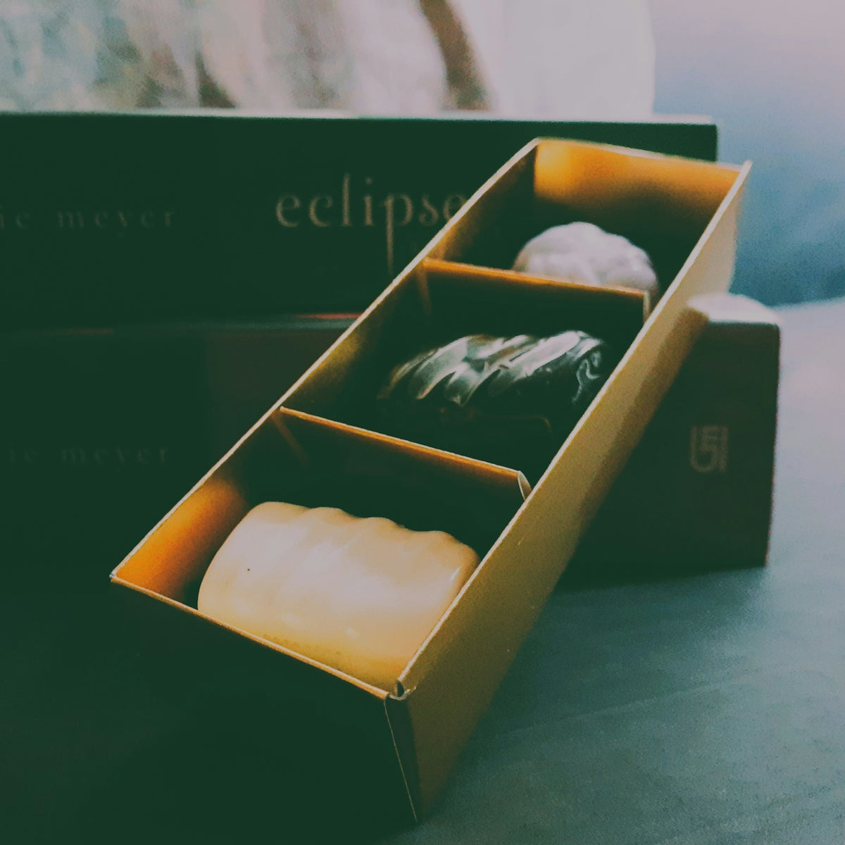 An open box of three gourmet chocolates