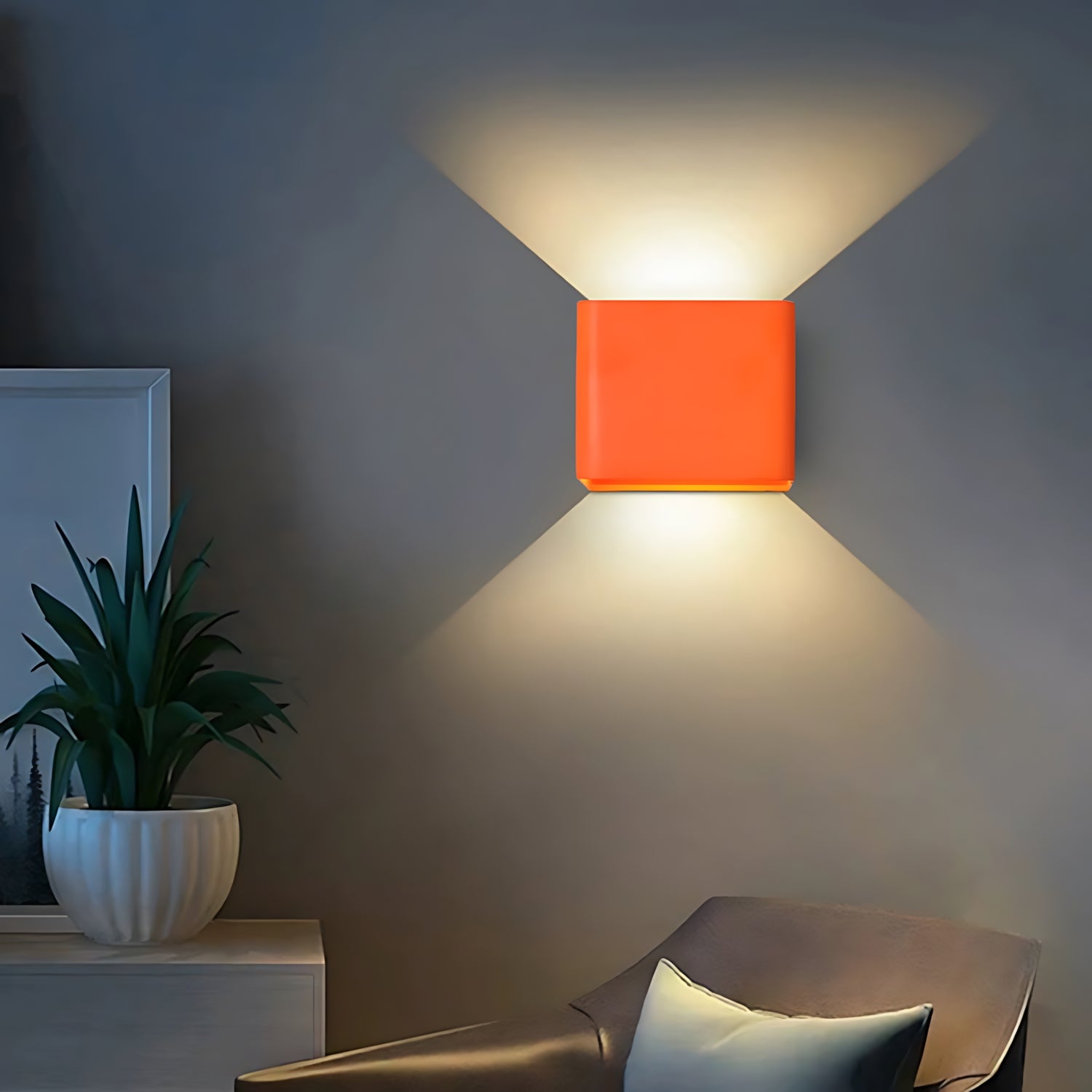 A modern square wall lamp with a sleek design, casting a soft glow on the wall in black, white, and green colors.