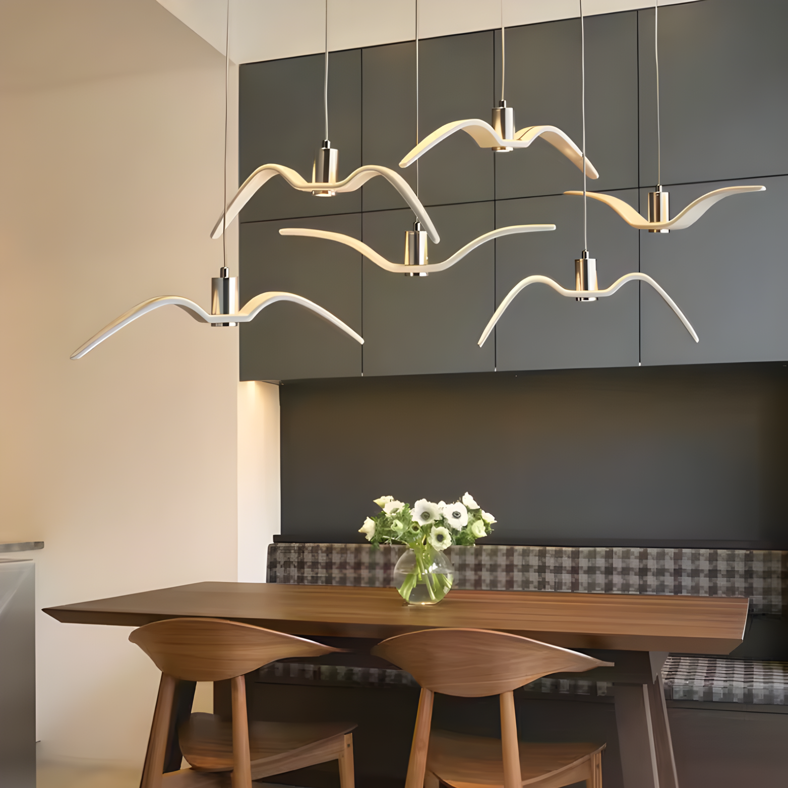 Modern dining room with abstract pendant lights, wooden table, and chairs.