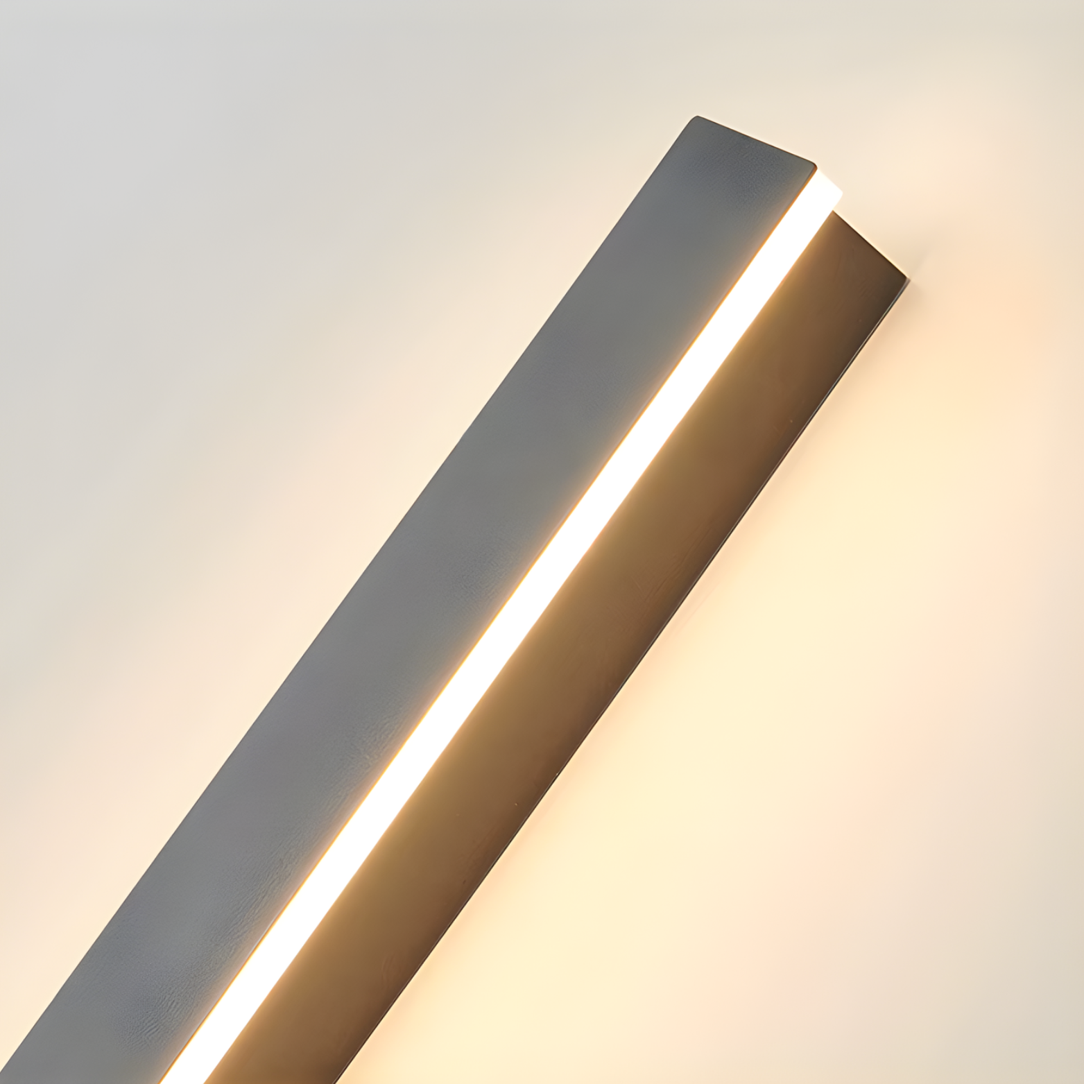 Modern wall-mounted light fixture on a neutral background