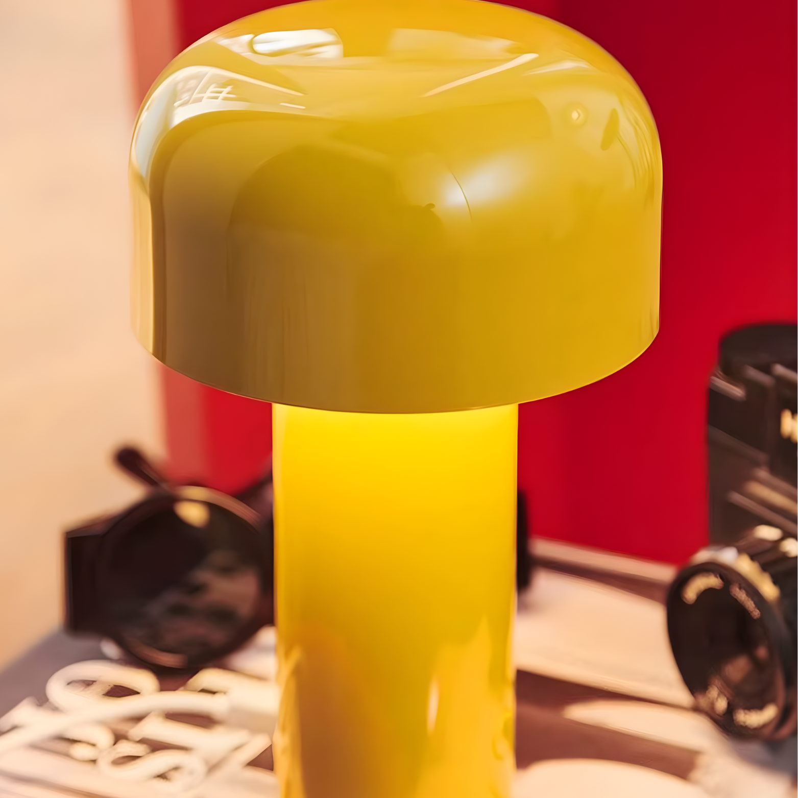 Yellow lamp with a red wall and blurred objects in the background