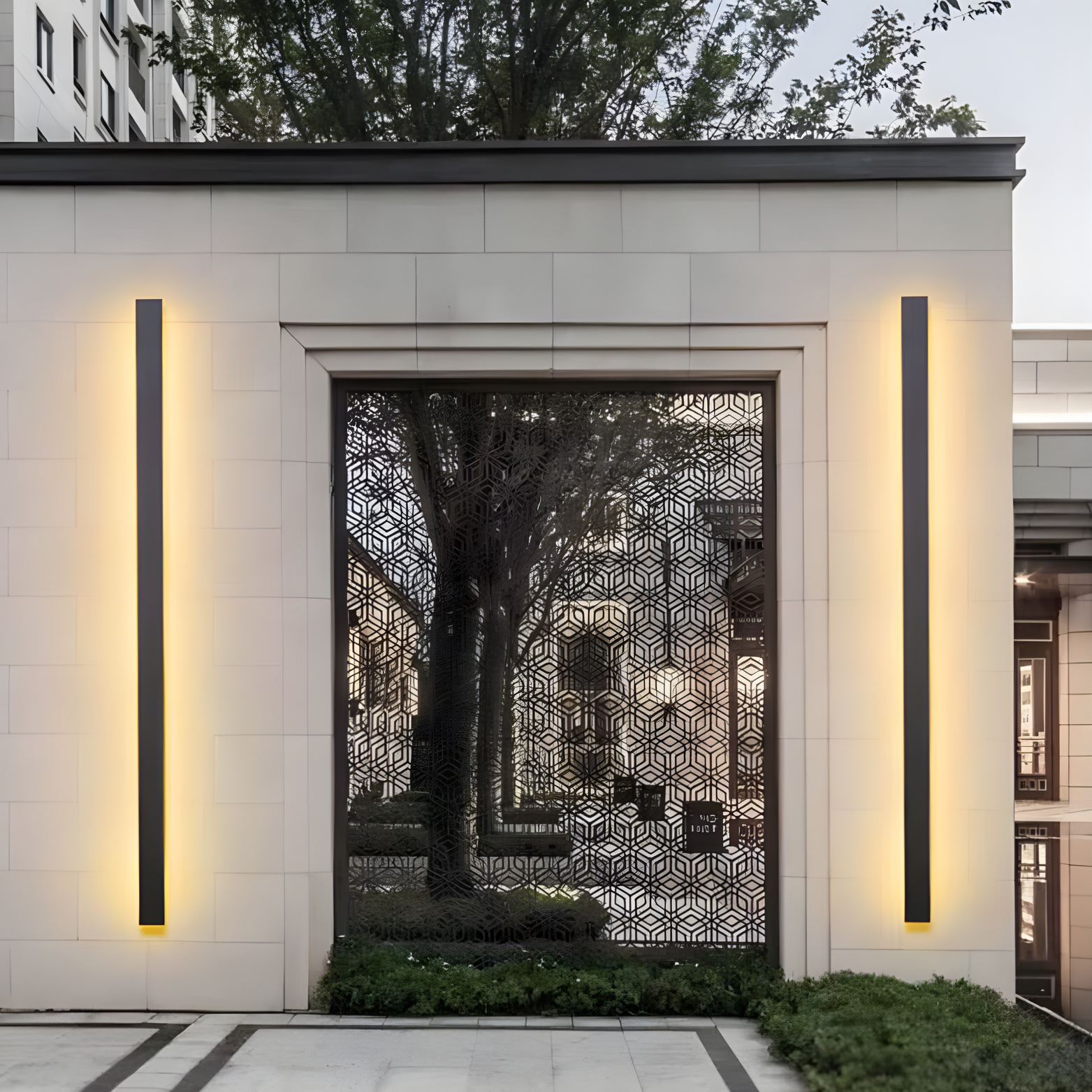 Modern architectural design with geometric wall patterns and illuminated vertical lights.