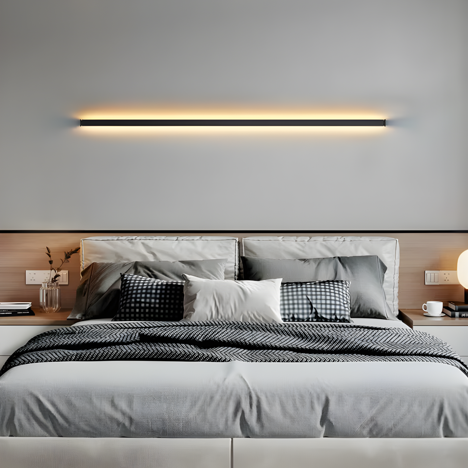 Modern bedroom with a bed, pillows, and wall-mounted light fixture.