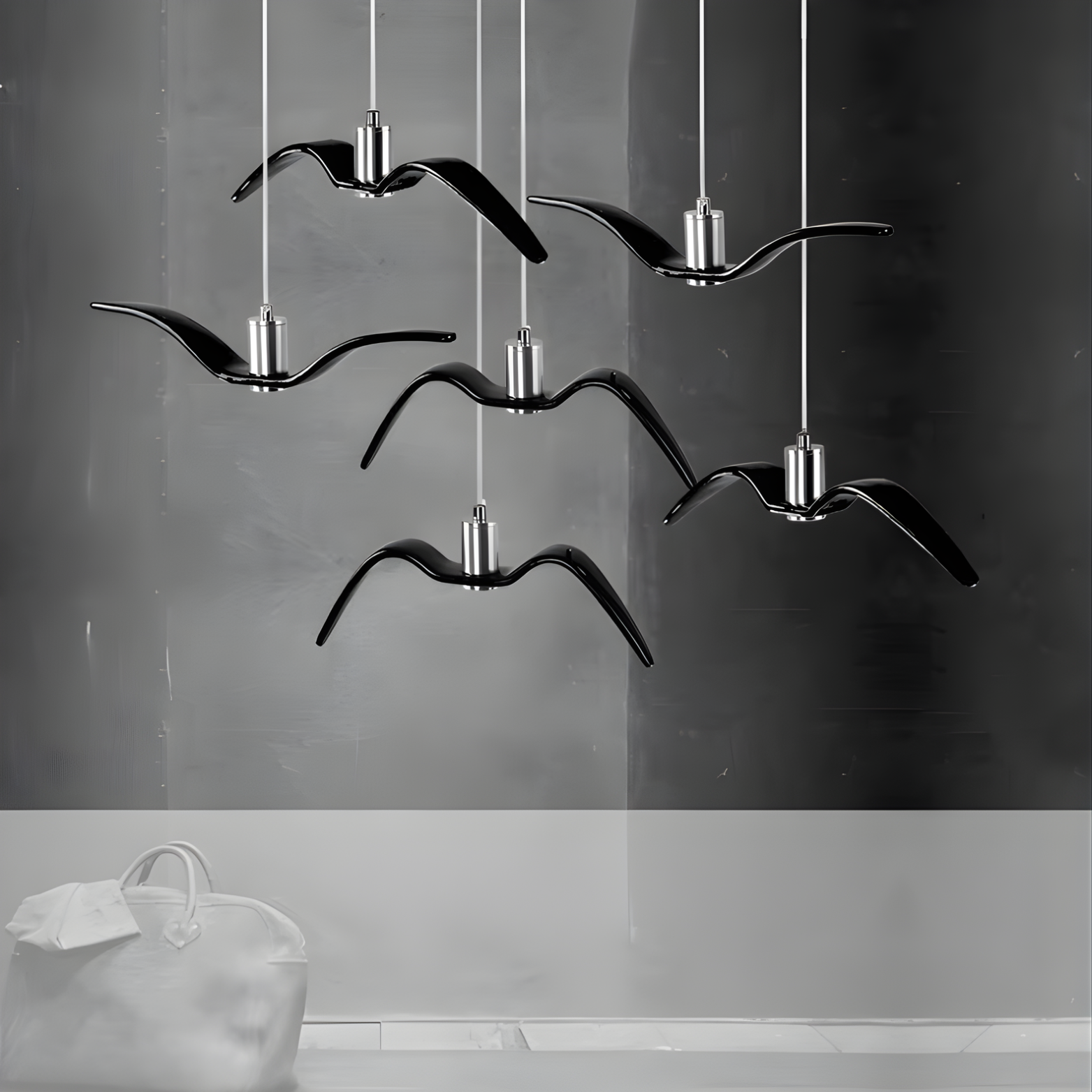 Modern chandelier with bird-shaped design on a gray background