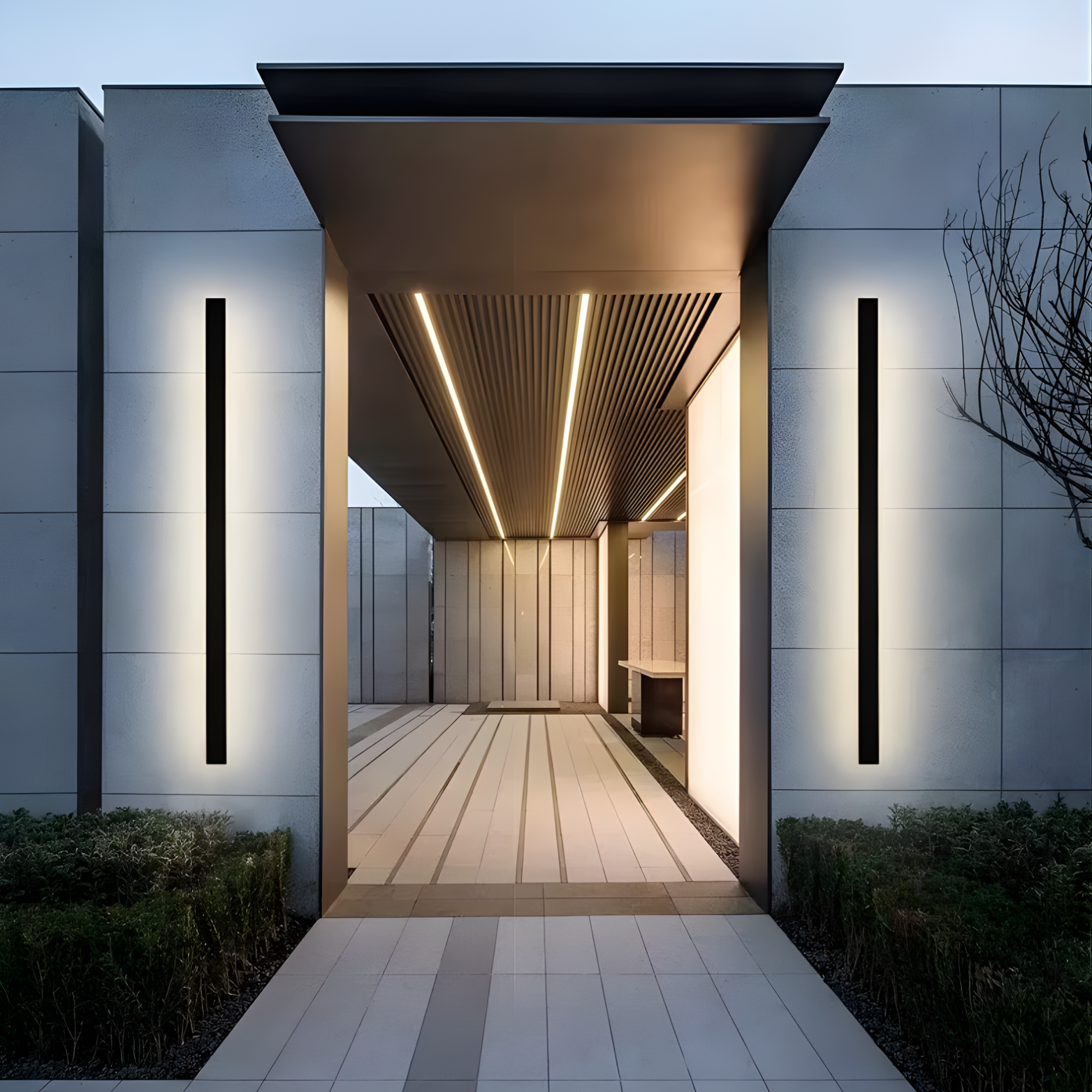 Modern architectural entrance with illuminated ceiling and wall lights