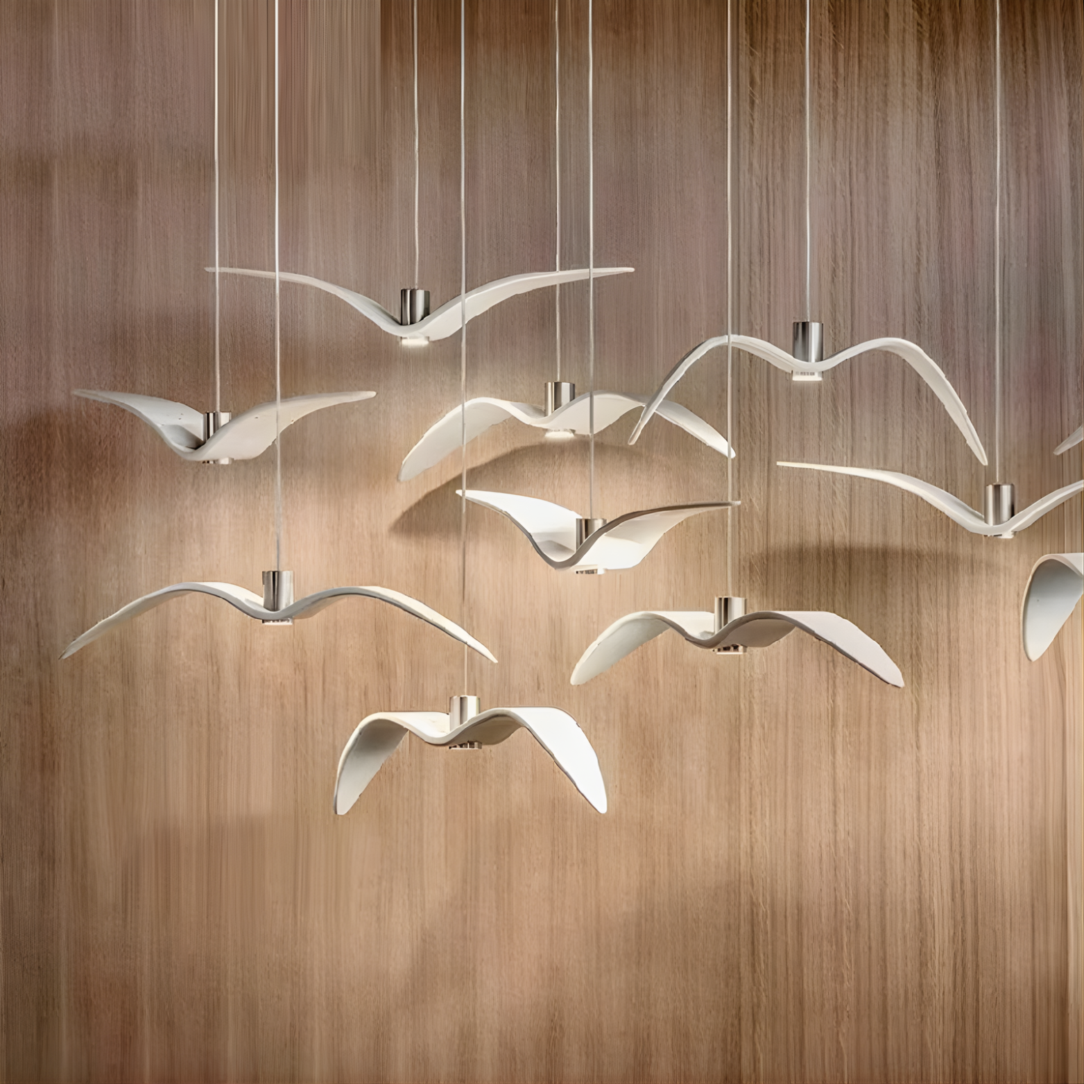 Chandelier with bird-shaped lights on a wooden background