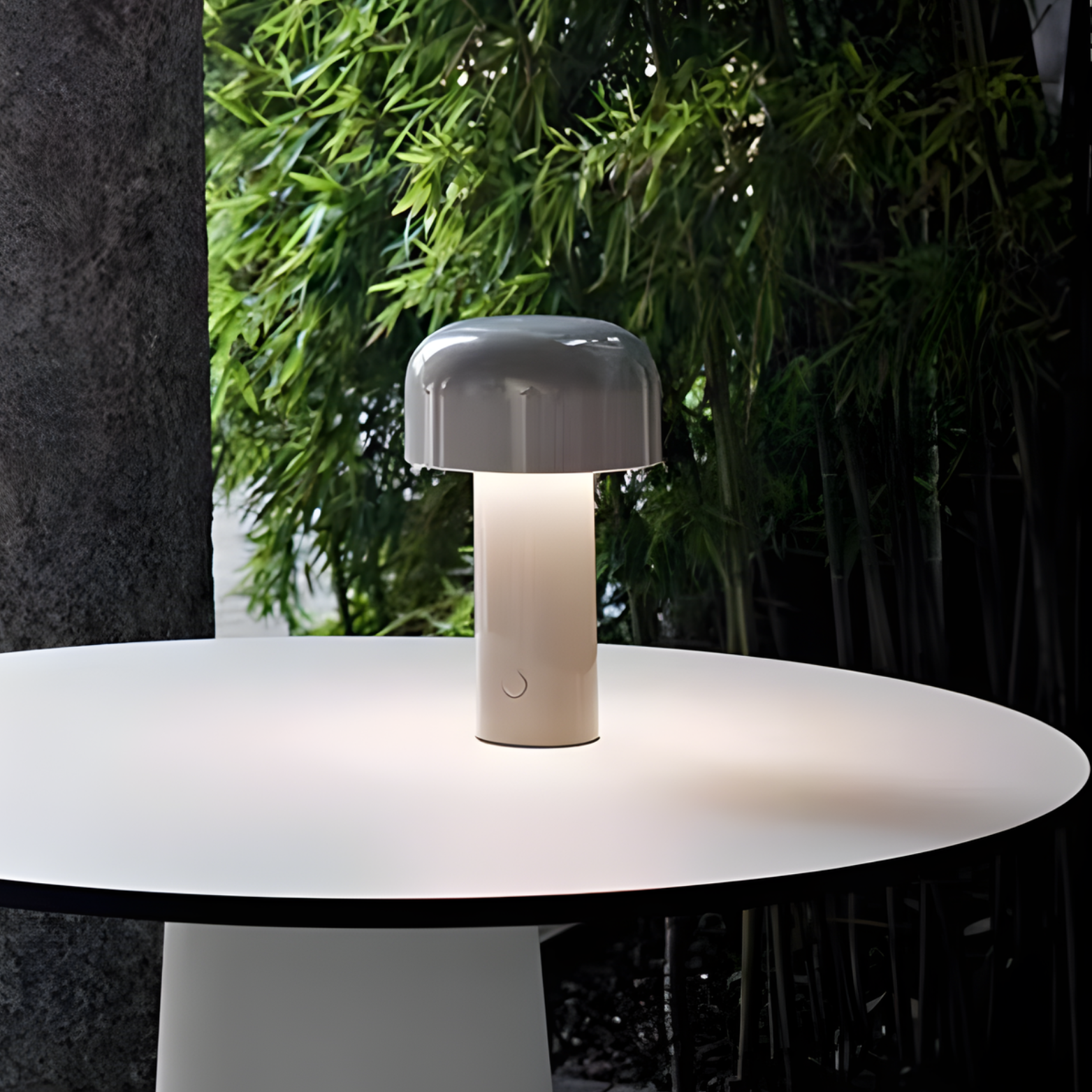 Mushroom-shaped lamp on a round table with greenery in the background