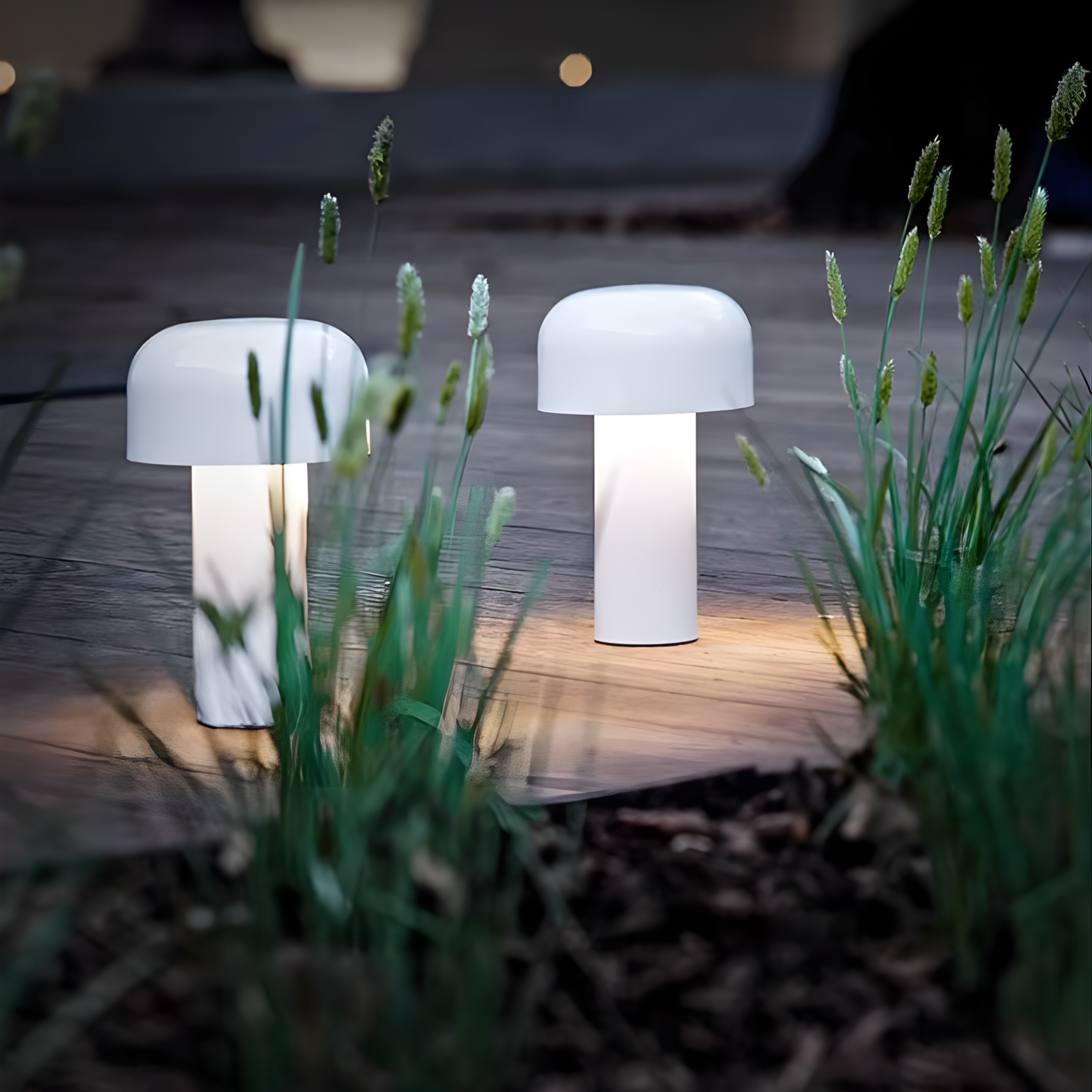 Two mushroom-shaped outdoor lights on a wooden deck with grass in the foreground