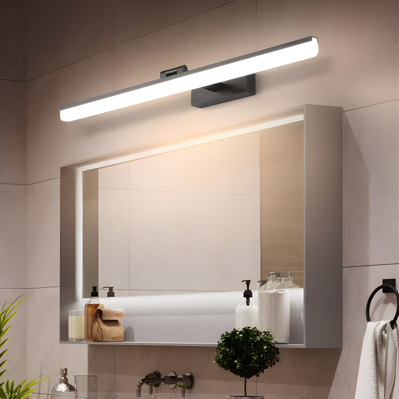 Bathroom vanity with mirror, light fixture, and decorative elements.