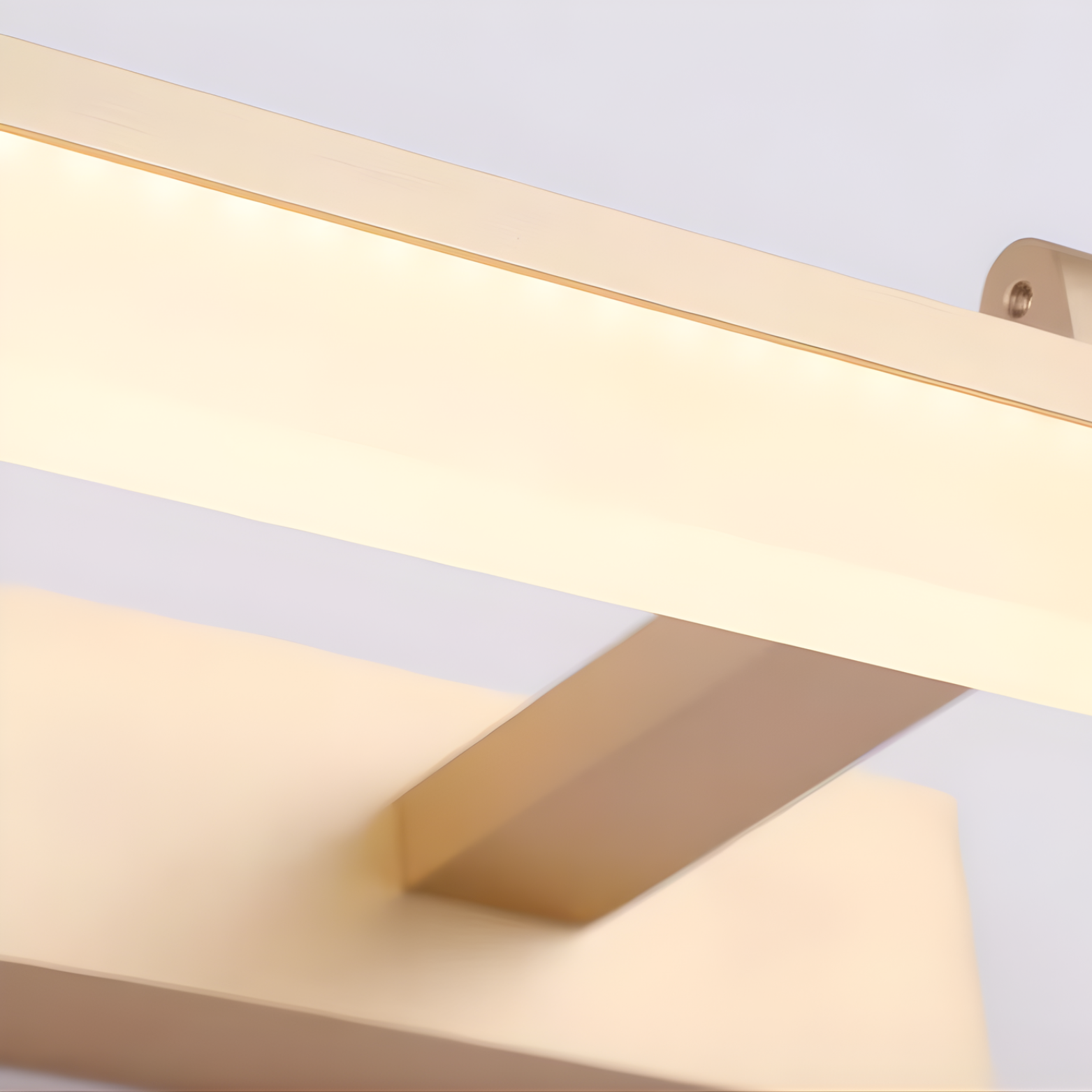 Close-up of a gold-colored metal bracket on a white background