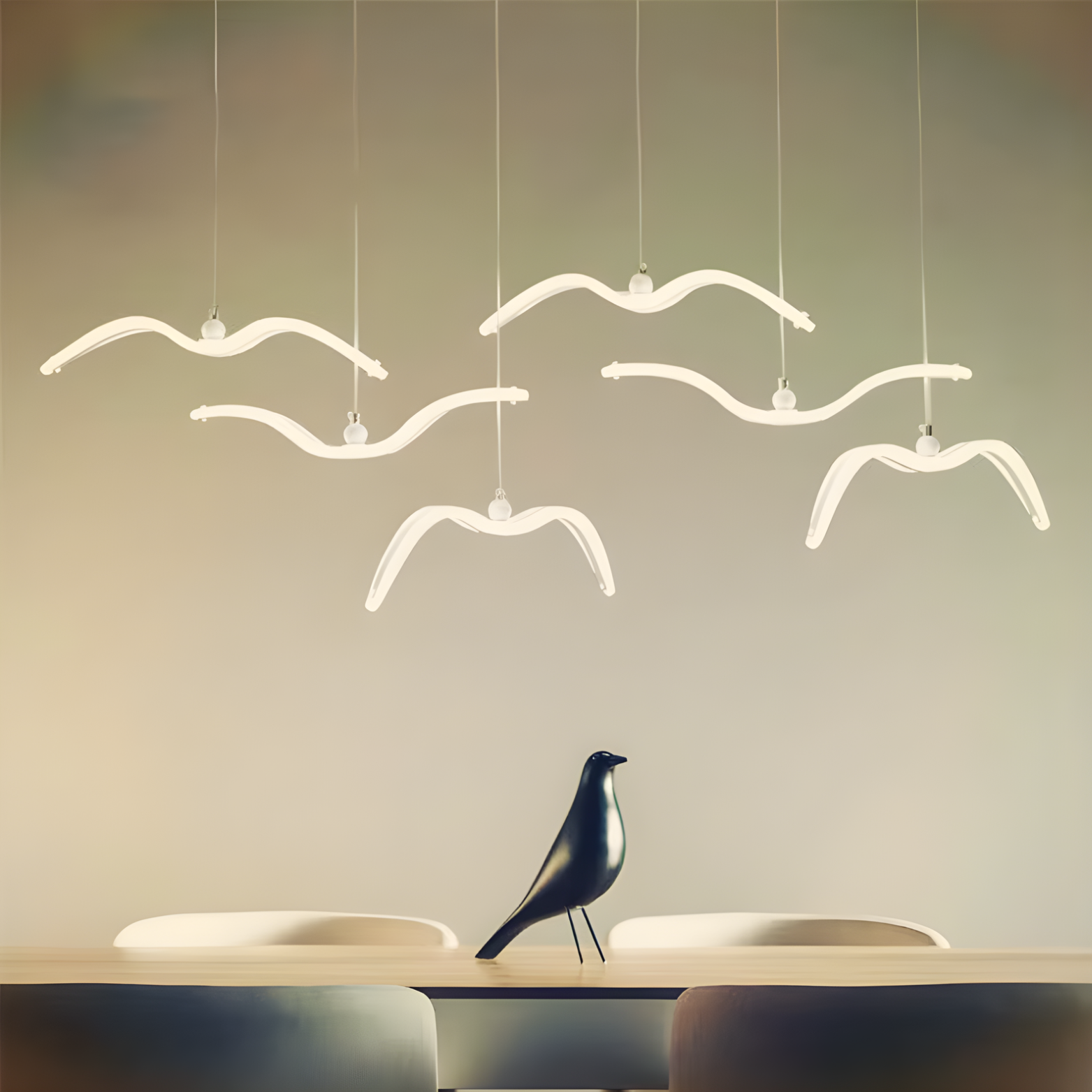 Modern pendant lights shaped like birds hanging above a dining table with a decorative bird sculpture.