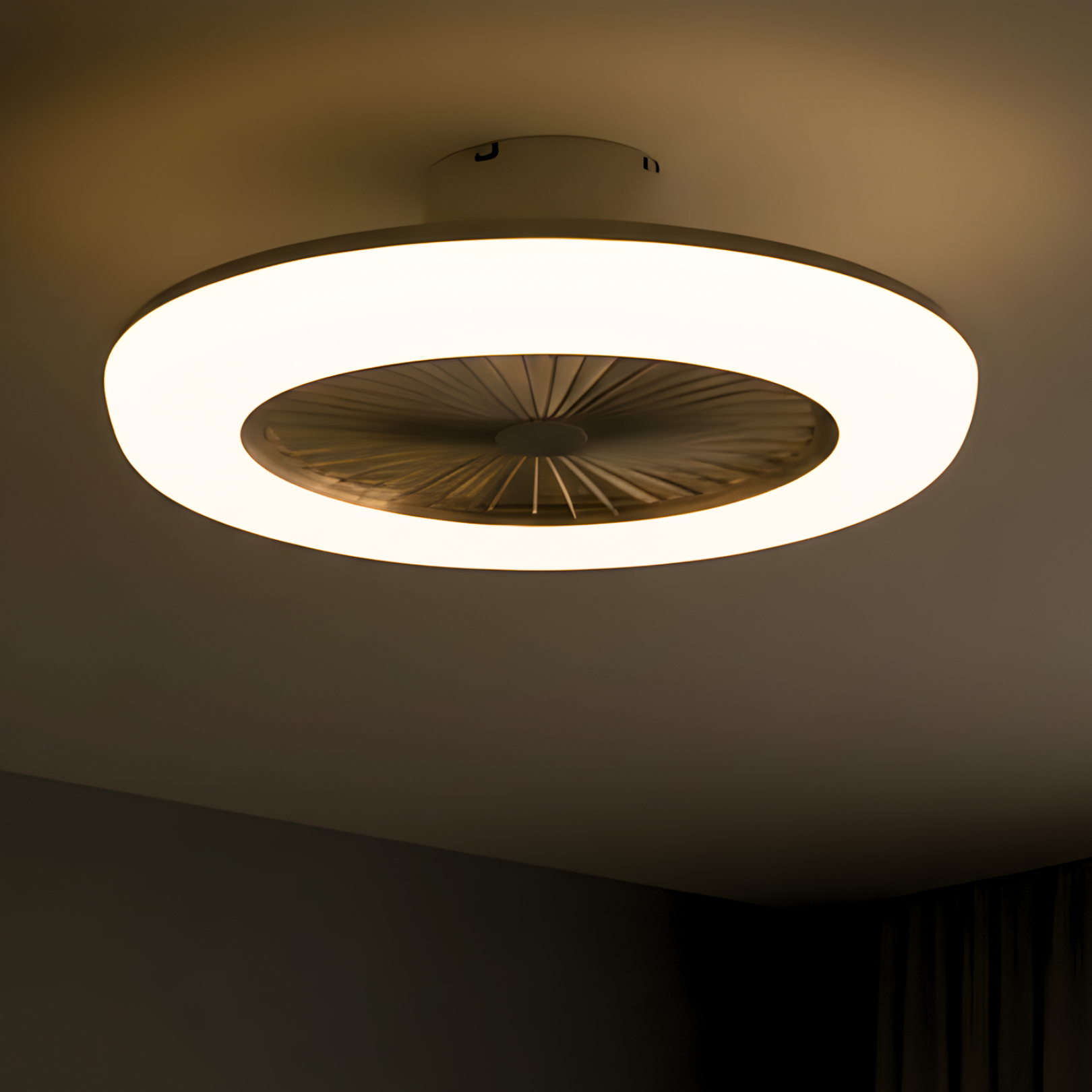 Ceiling light fixture with a warm glow on a dark ceiling