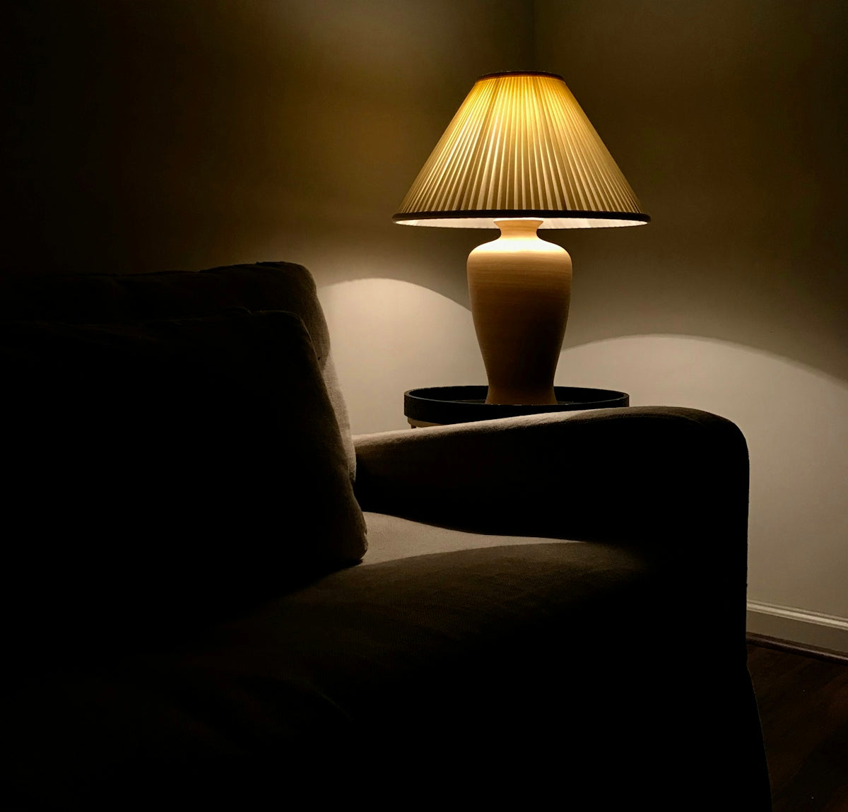 a lamp on a table next to a couch