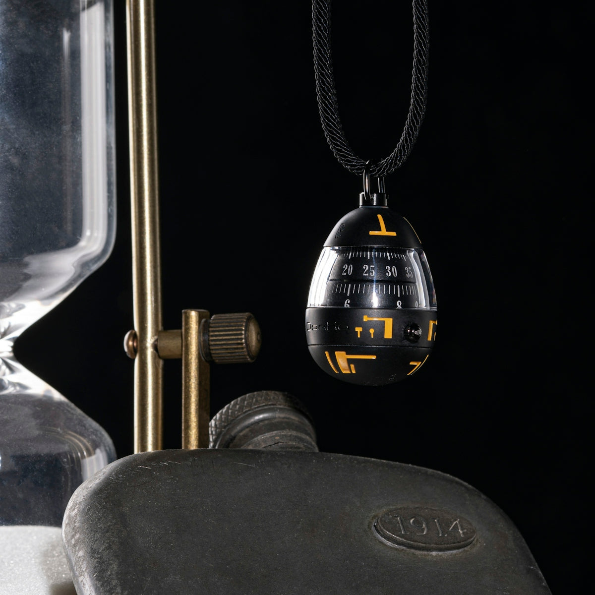 a close up of a metal object on a chain