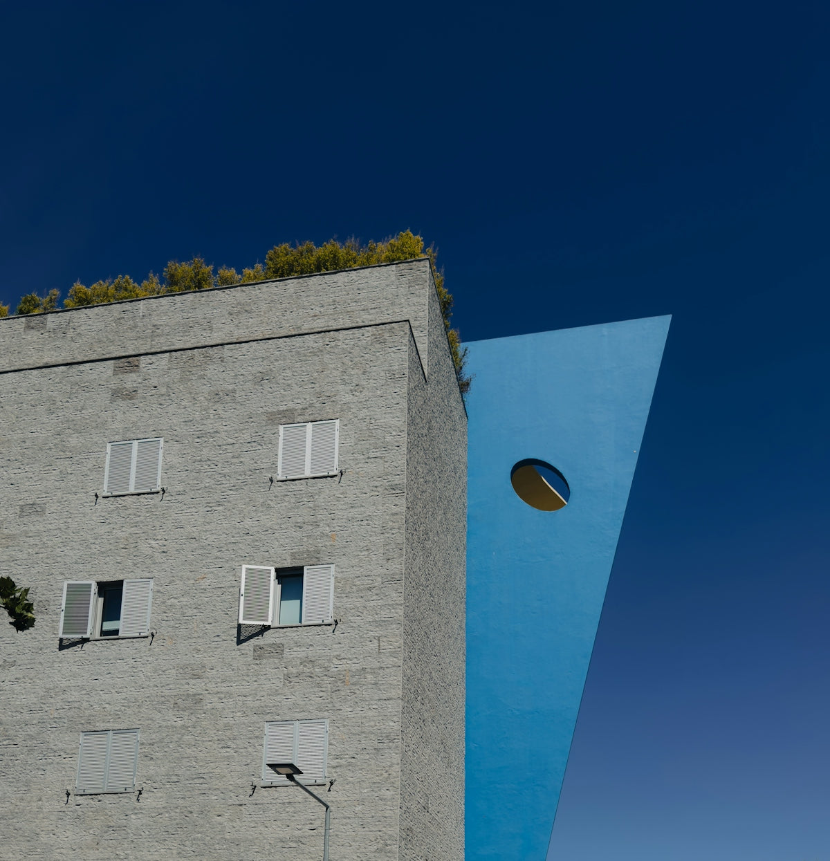 a tall building with a blue triangle on the side of it