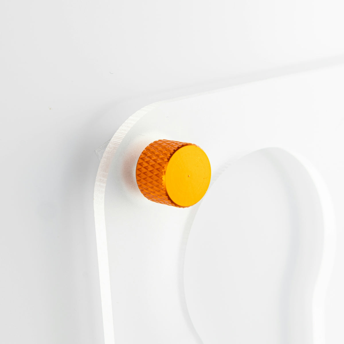 a white wall with a yellow button on it
