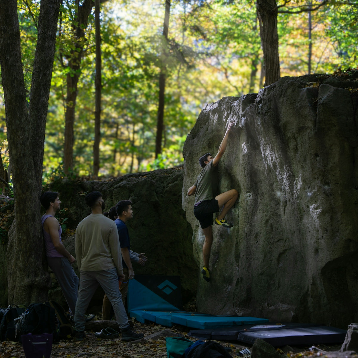 A group of people climbing up a rock face