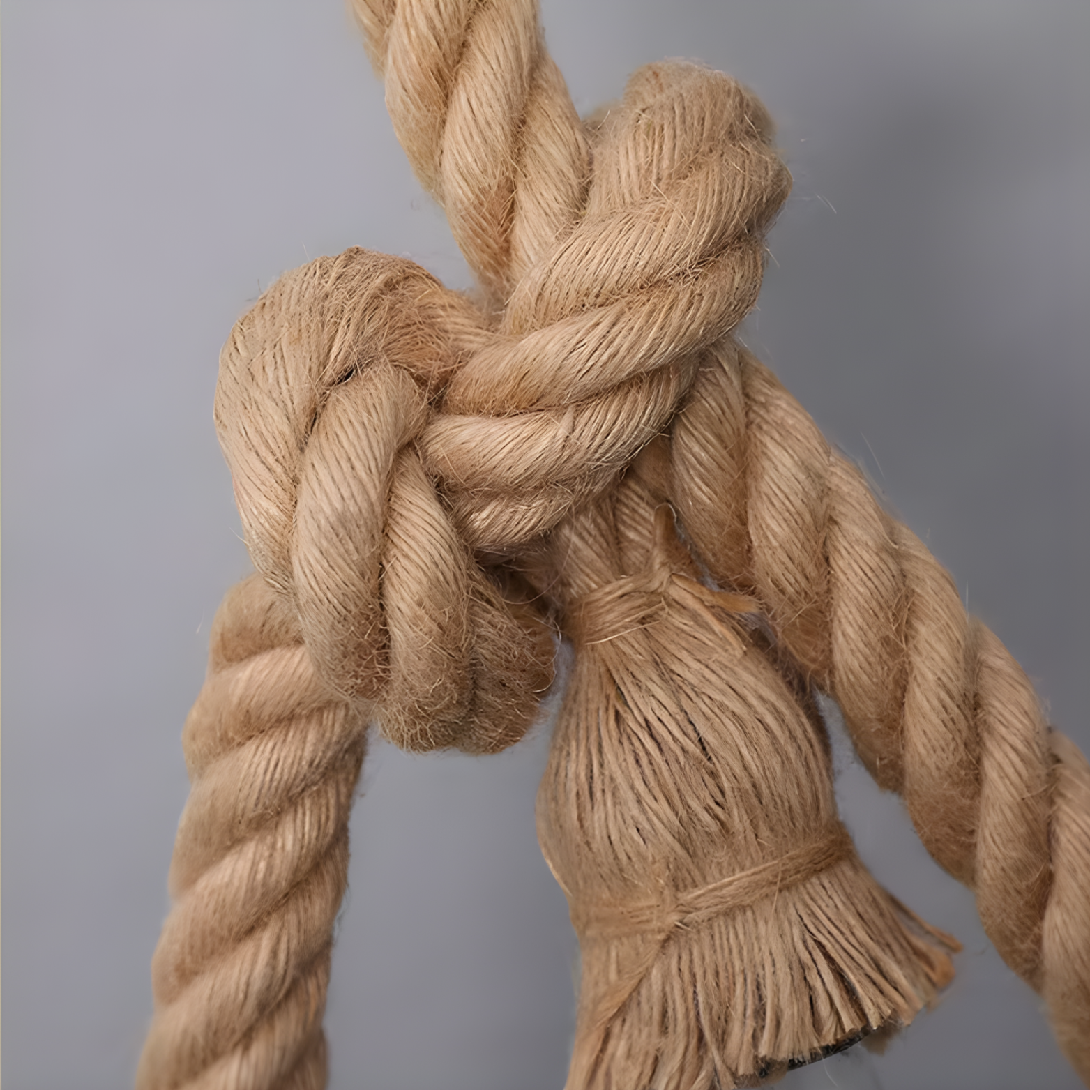 Close-up of a knotted rope on a gray background
