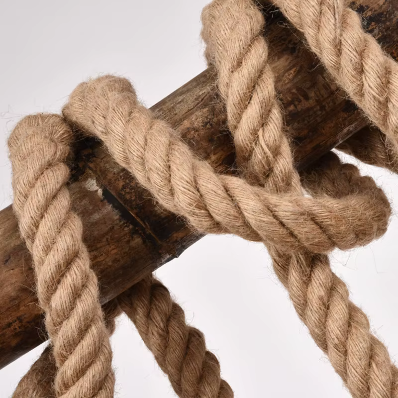 Pendant light Close-up of a rope tied around a wooden post on a white background