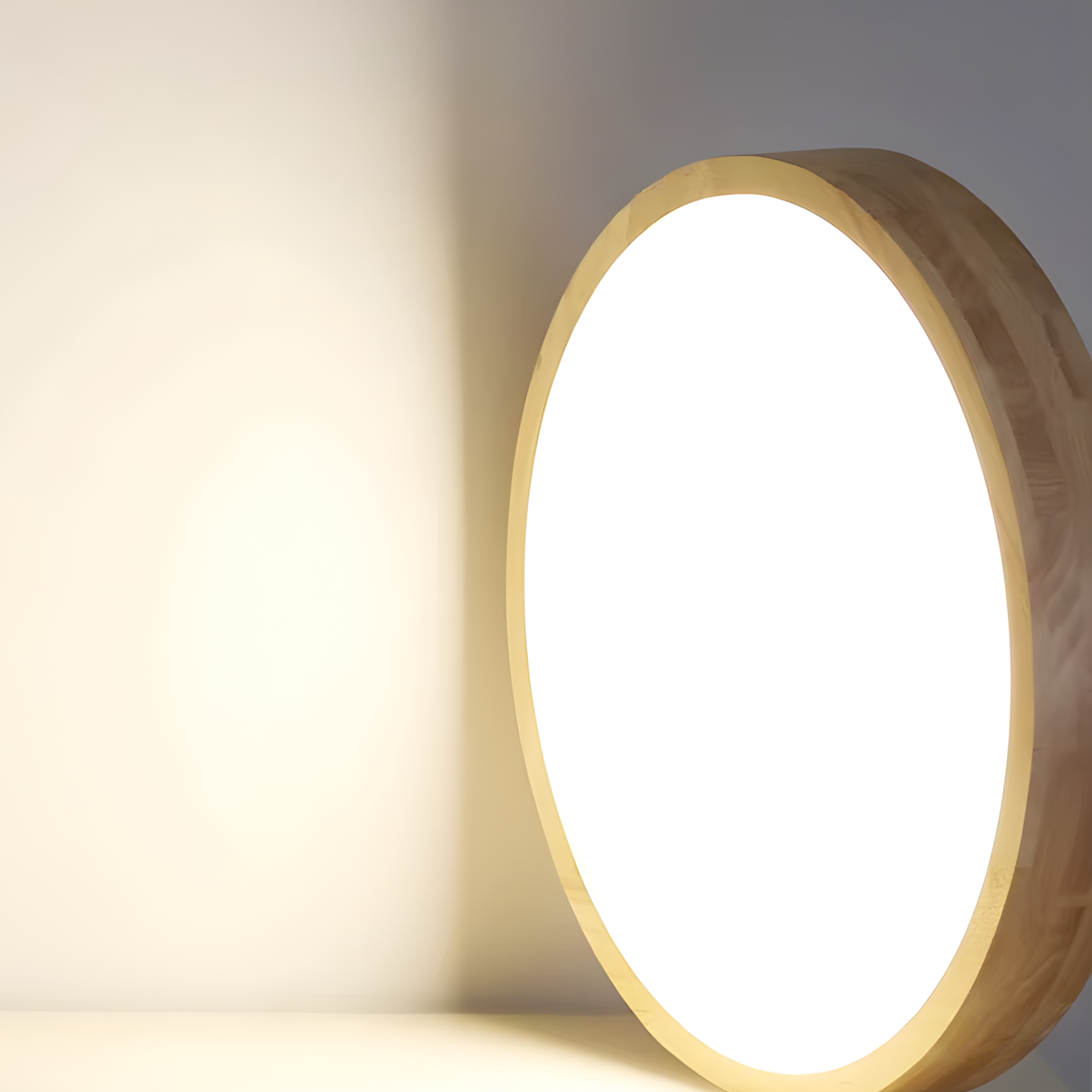 Round wooden light fixture casting a warm glow on a neutral background