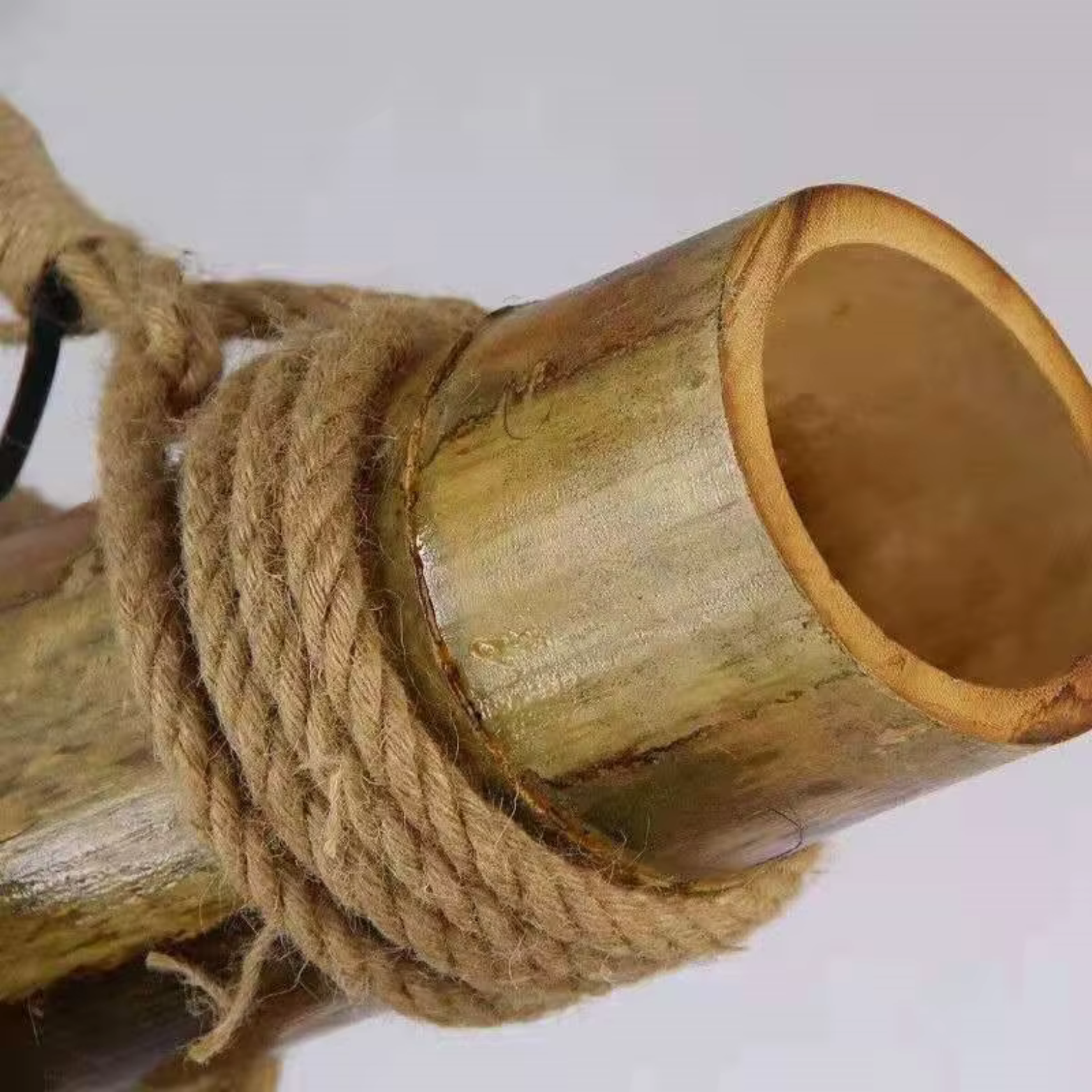 Pendant Light Close-up of a bamboo tube wrapped with twine on a white background