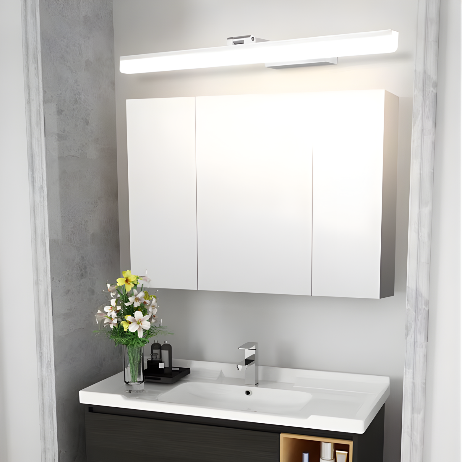Bathroom vanity with mirror, light fixture, and decorative elements.