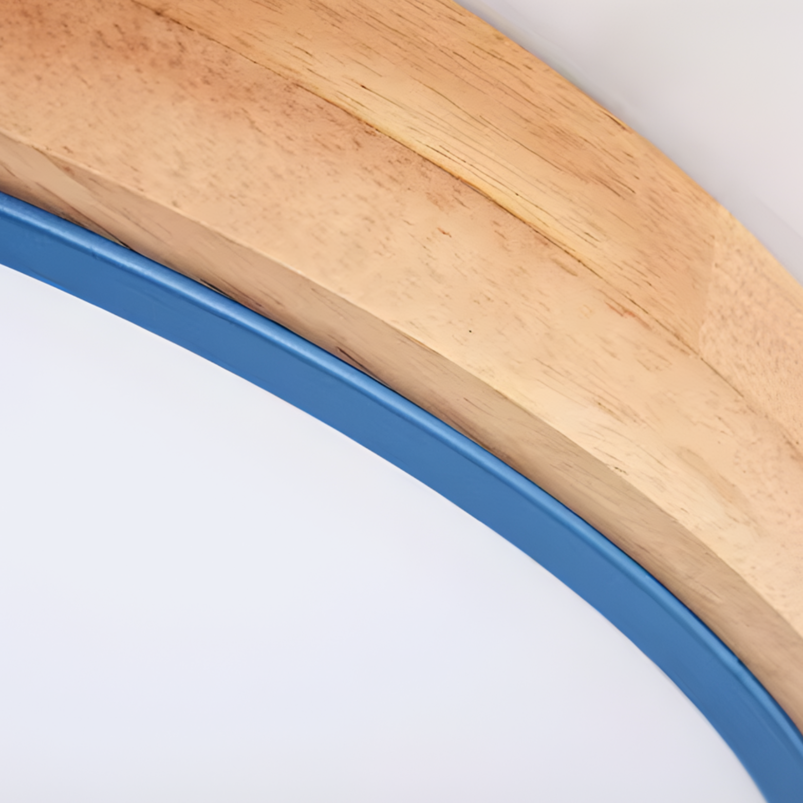 Close-up of a wooden frame with a blue border on a white background