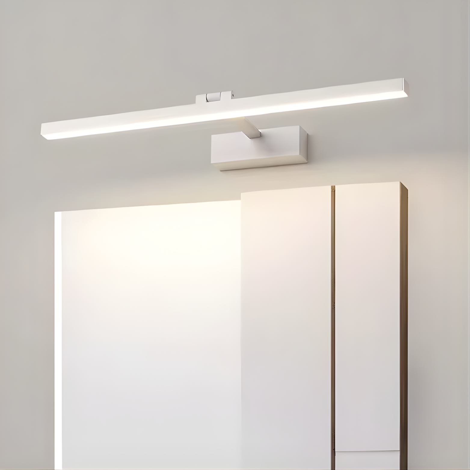 Modern wall-mounted light fixture above a mirror in a bathroom setting.