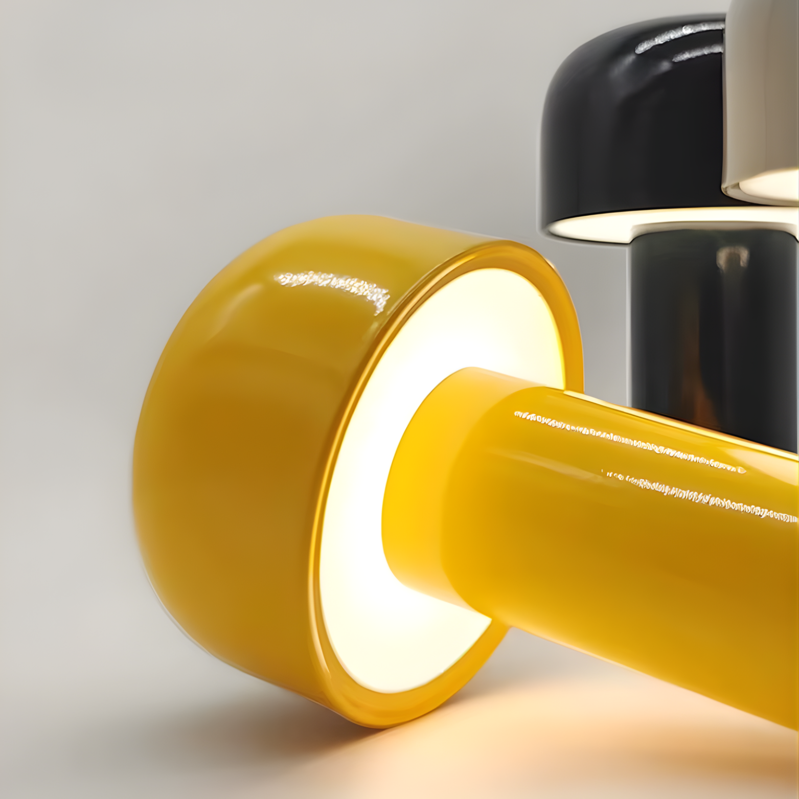 Yellow cylindrical lamp with a black counterpart on a light gray background