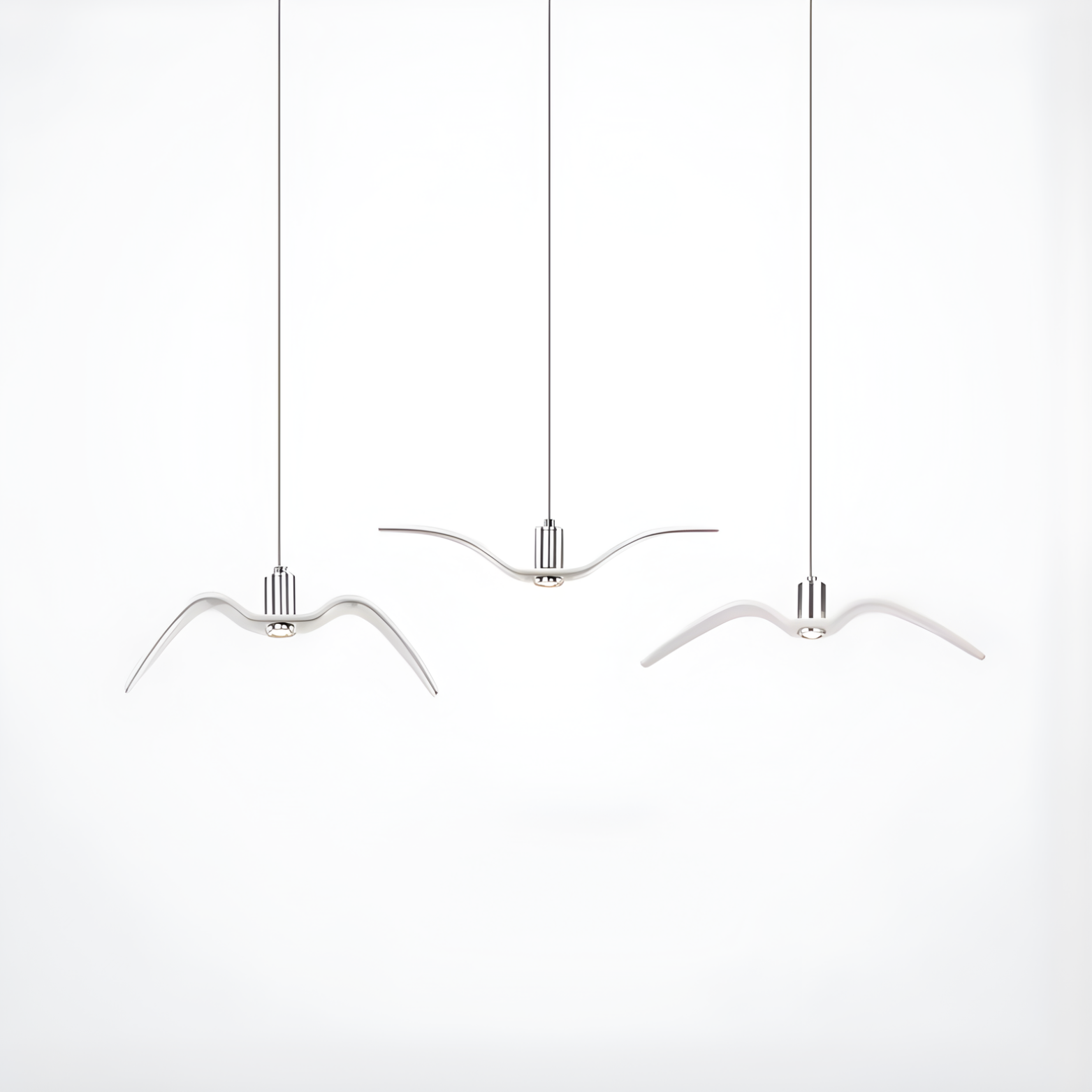 Three modern pendant lights shaped like birds on a white background