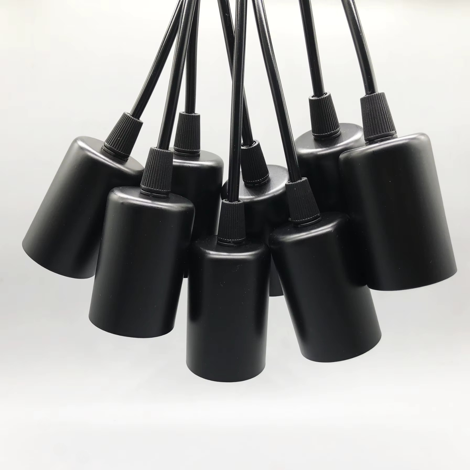 Set of black pendant lights on a white background