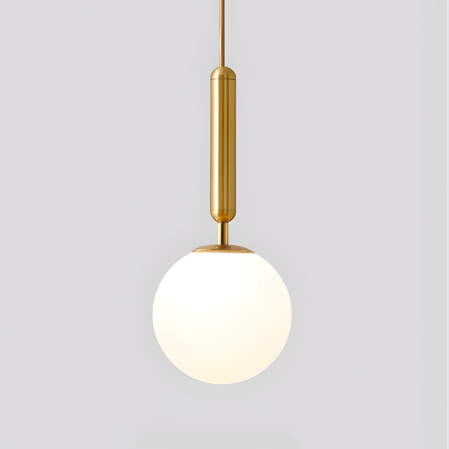 Modern pendant light with gold fixture and white glass shade on a light gray background