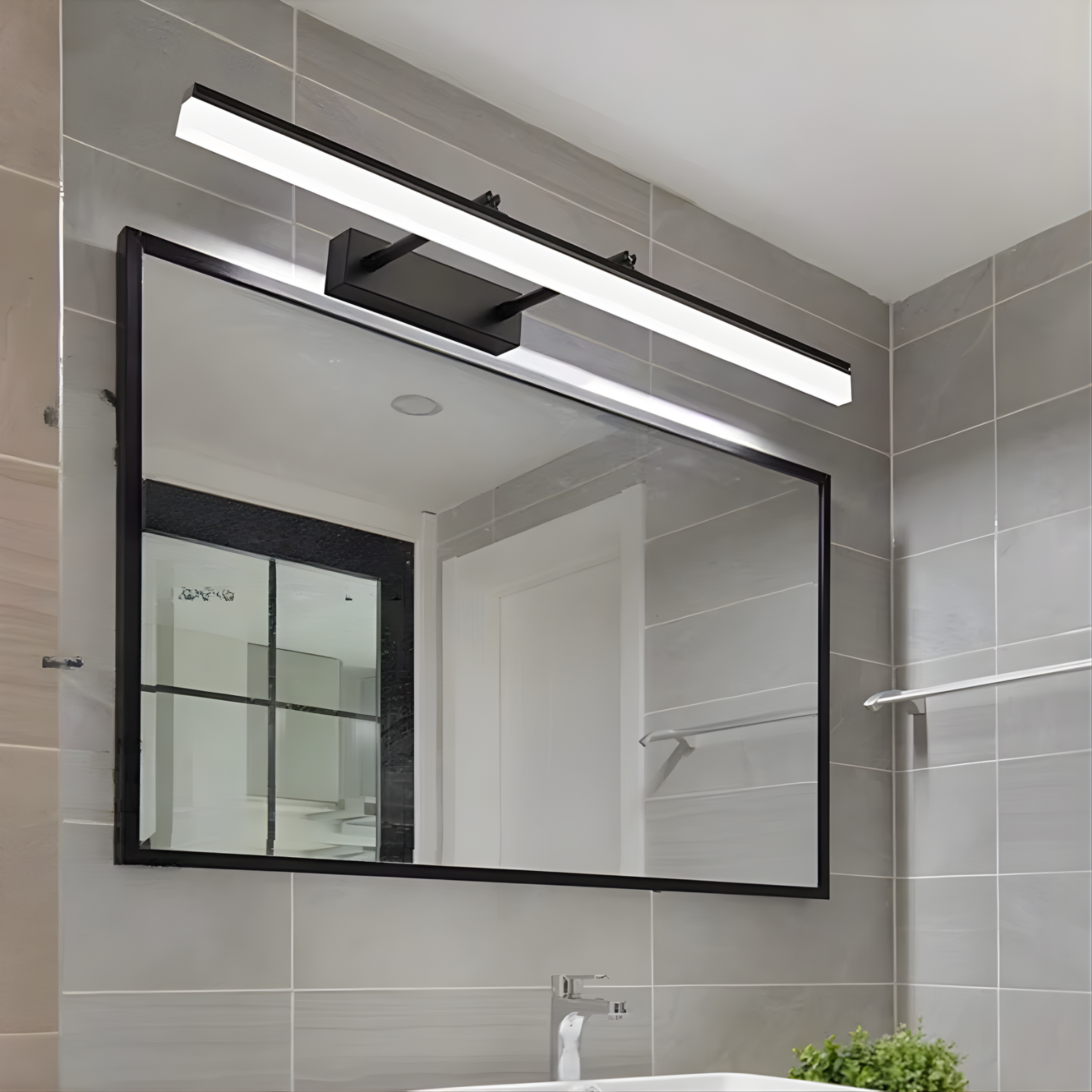 Bathroom mirror with a modern light fixture above it