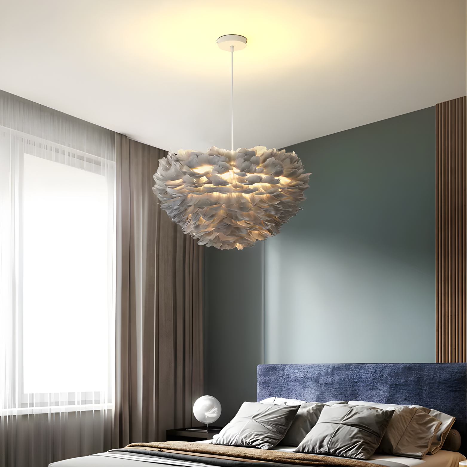 Modern bedroom with a feathered chandelier, bed, and window.
