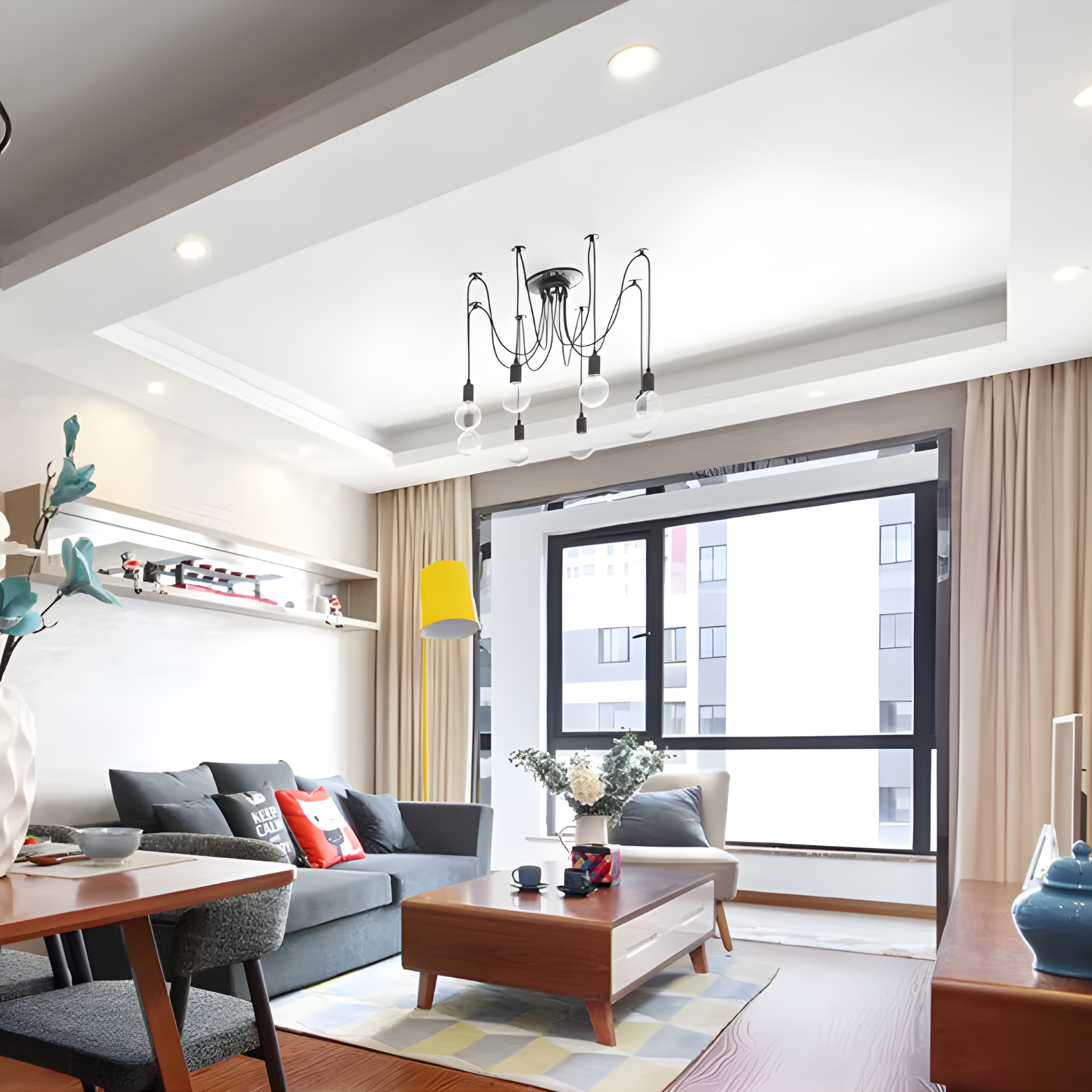 Modern living room with gray sofa, wooden coffee table, and large window.