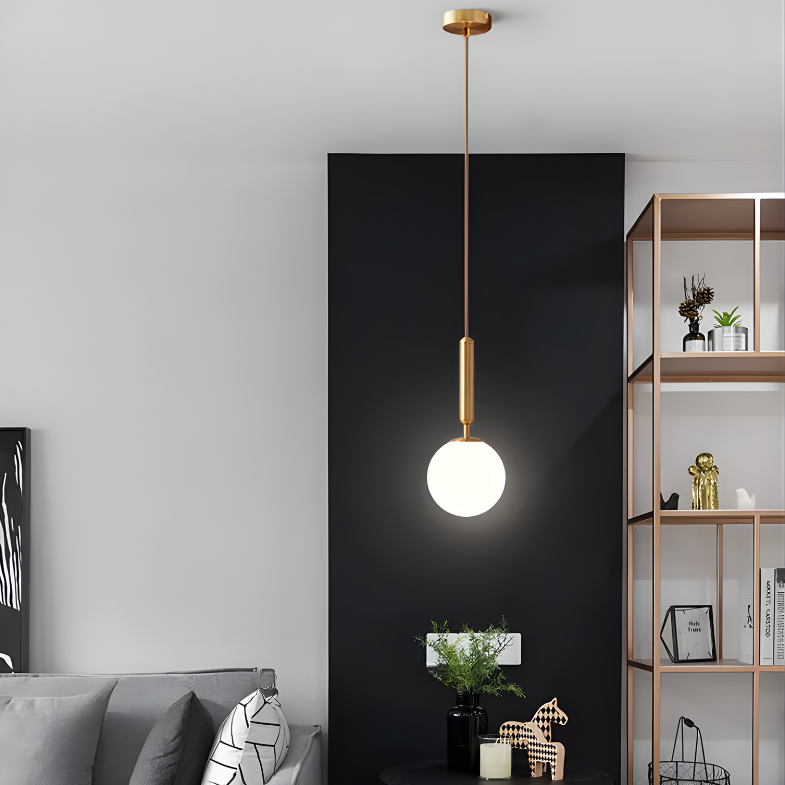 Modern pendant light hanging in a living room setting with a black wall and shelves.