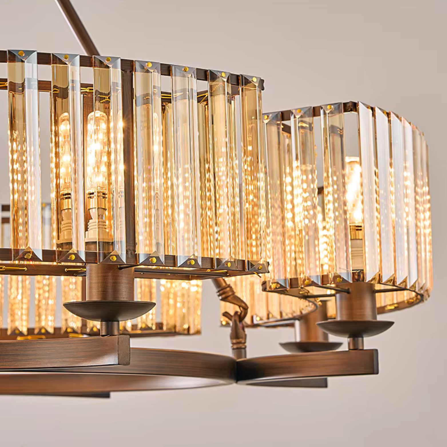 Chandelier with glass panels and bronze accents on a neutral background