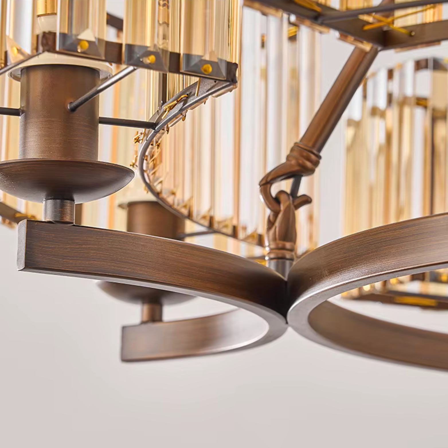 Close-up of a bronze ceiling fan with a blurred background