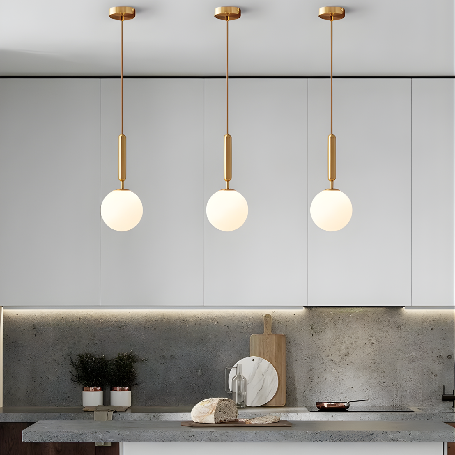 Modern kitchen with pendant lights hanging above a countertop.