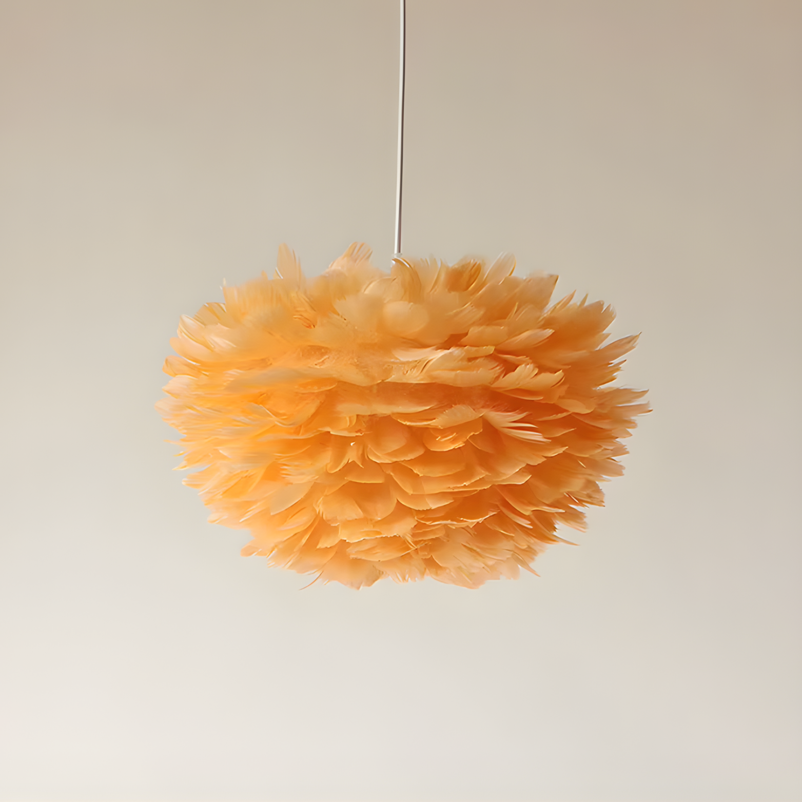 Orange feathered pendant light against a plain background