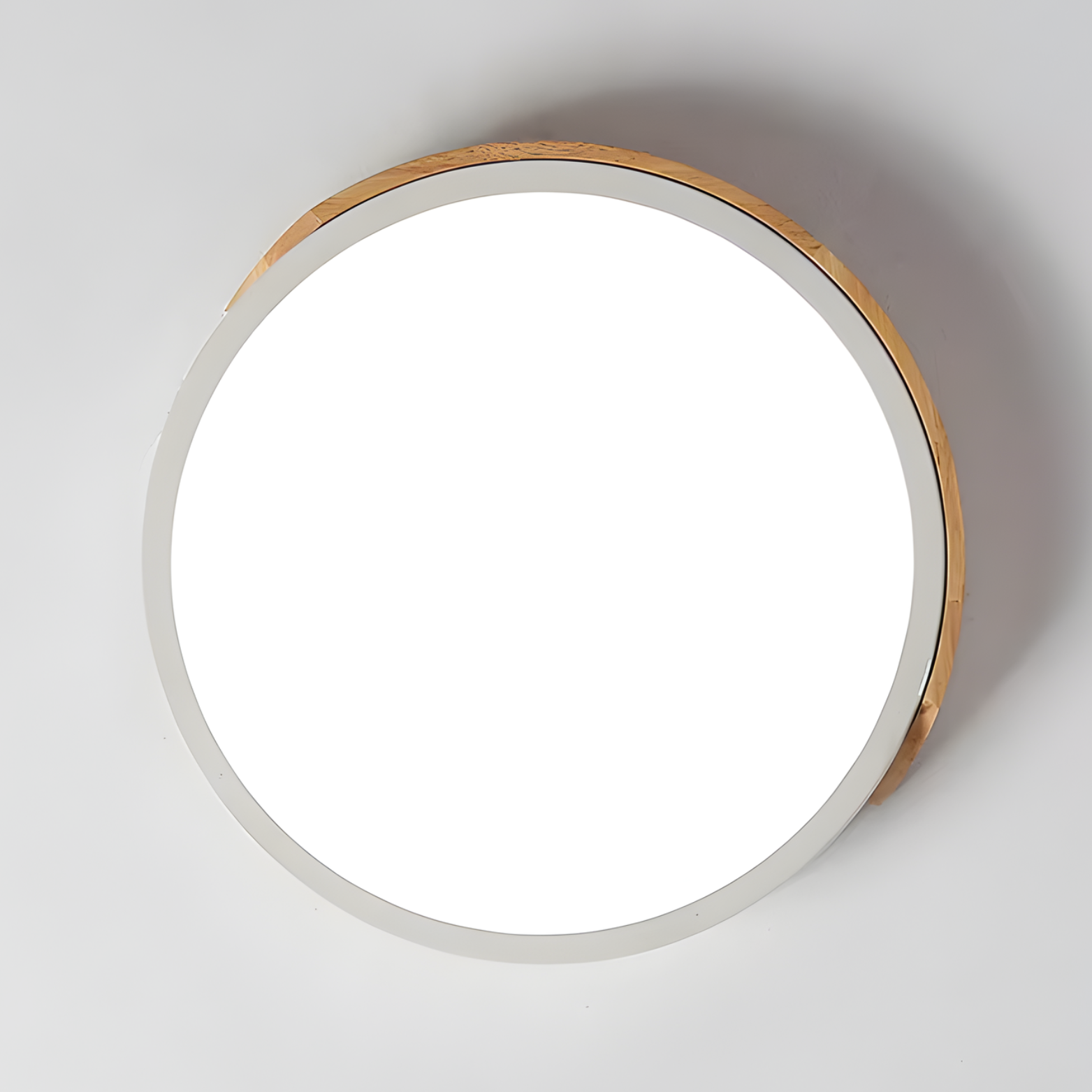 Round ceiling light fixture with wooden frame on a white ceiling