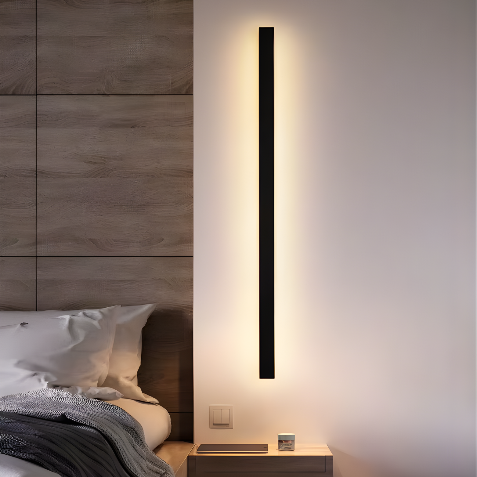 Modern wall-mounted light fixture on a bedroom wall