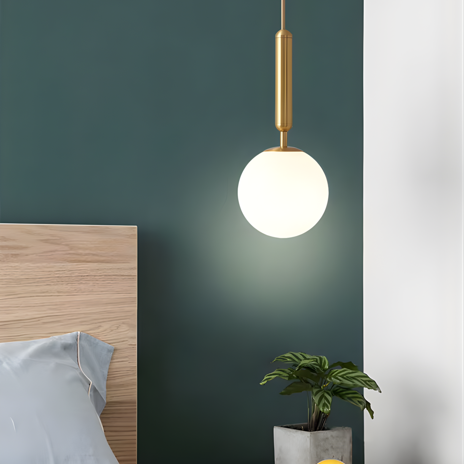 Pendant light fixture in a bedroom with a green wall and wooden headboard.