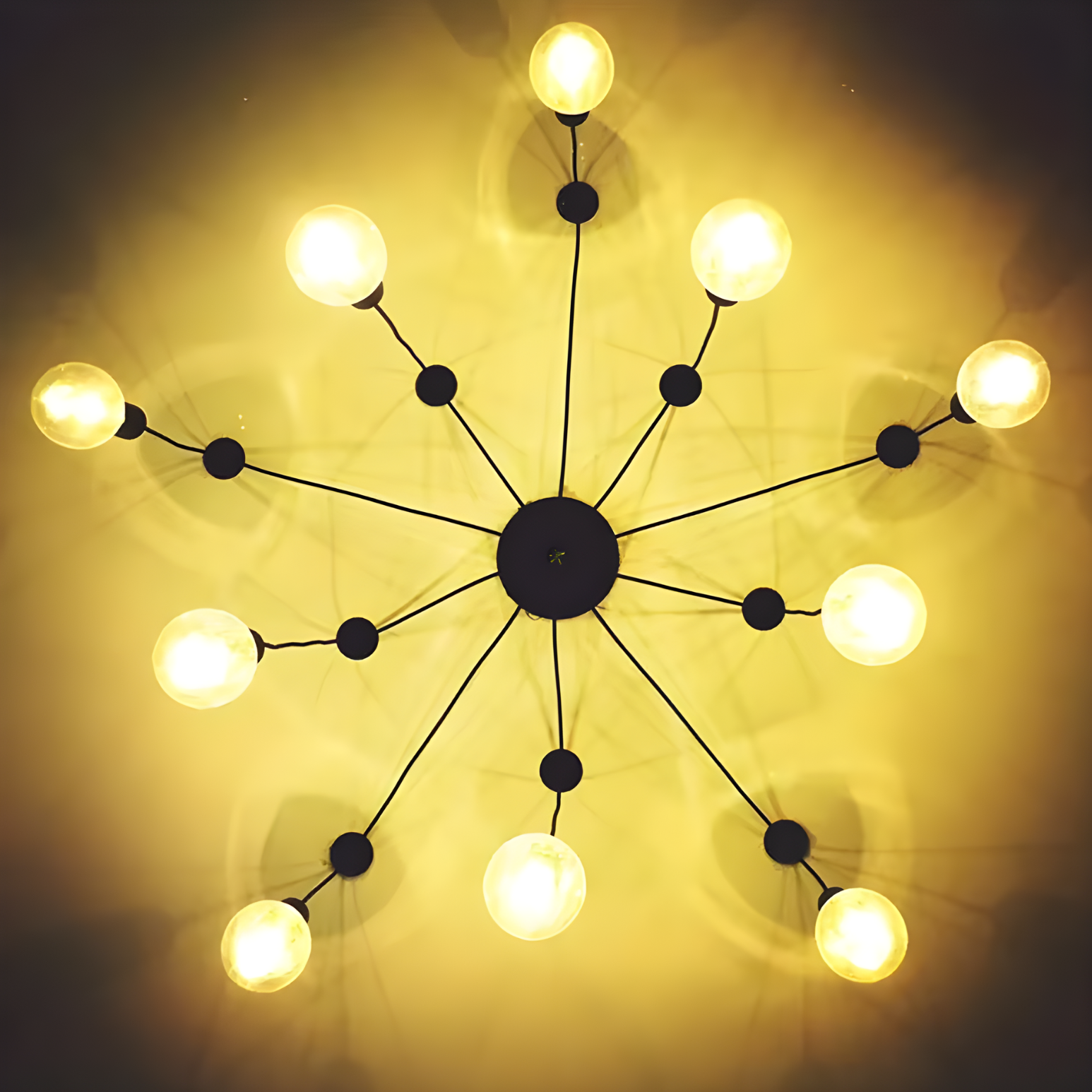 Modern chandelier with multiple light bulbs on a dark background
