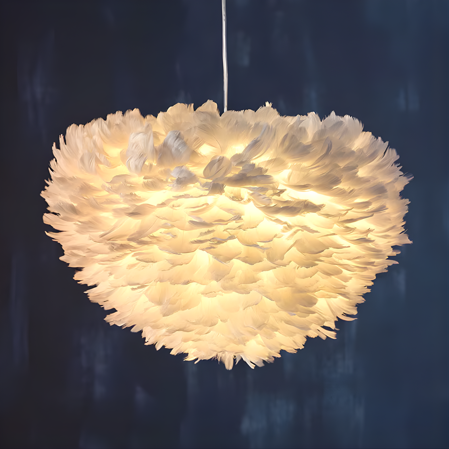 Feather-like pendant light against a dark background
