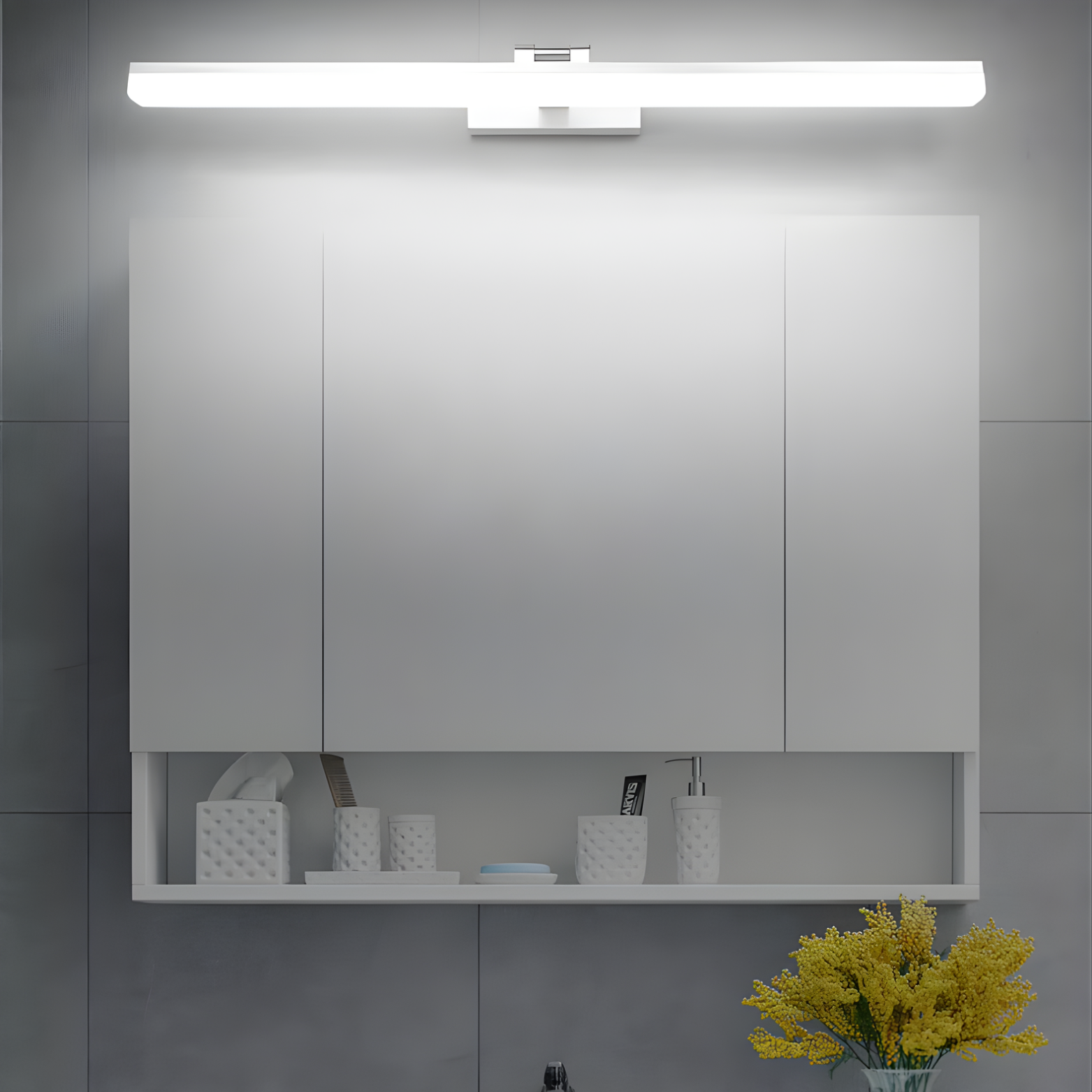 Bathroom mirror with light fixture above, shelves below, and decorative elements.