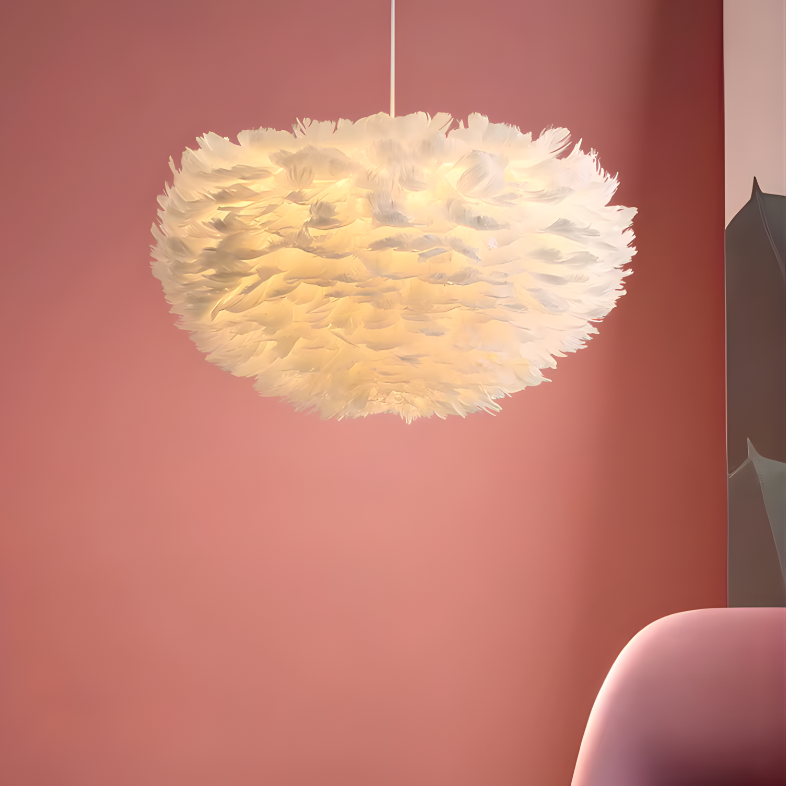 Feathered pendant light fixture against a pink wall