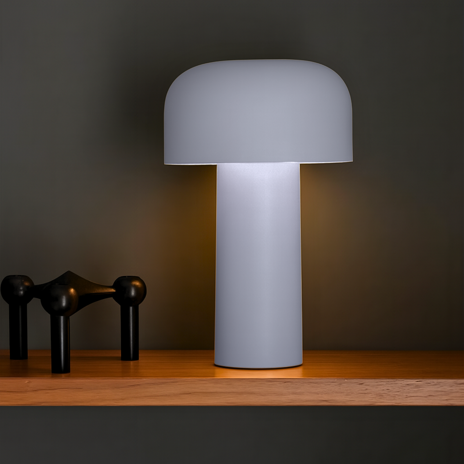 Gray table lamp on a wooden surface with a dark background